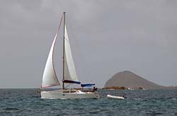 A sailboat passes us on the way to Tobago Cays