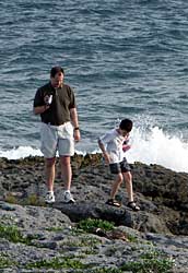 Larry and Jacob play by the ocean